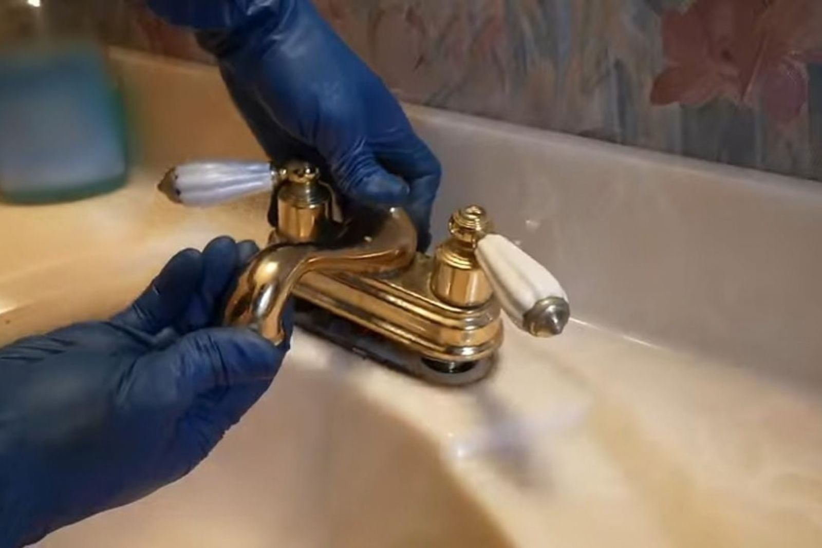 Plumber repairing a kitchen faucet under a Fort Myers, FL sink
